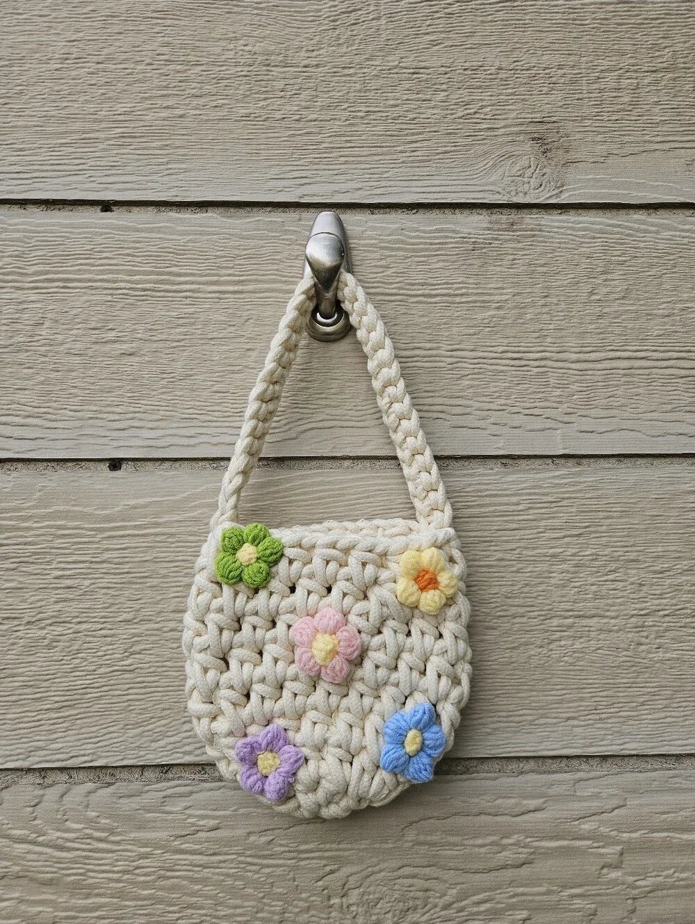 cream colored chunky crochet bag with flowers